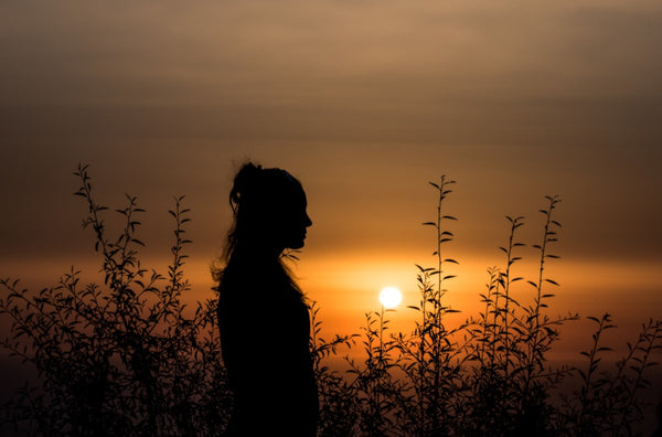Woman. Sunrise, herbs